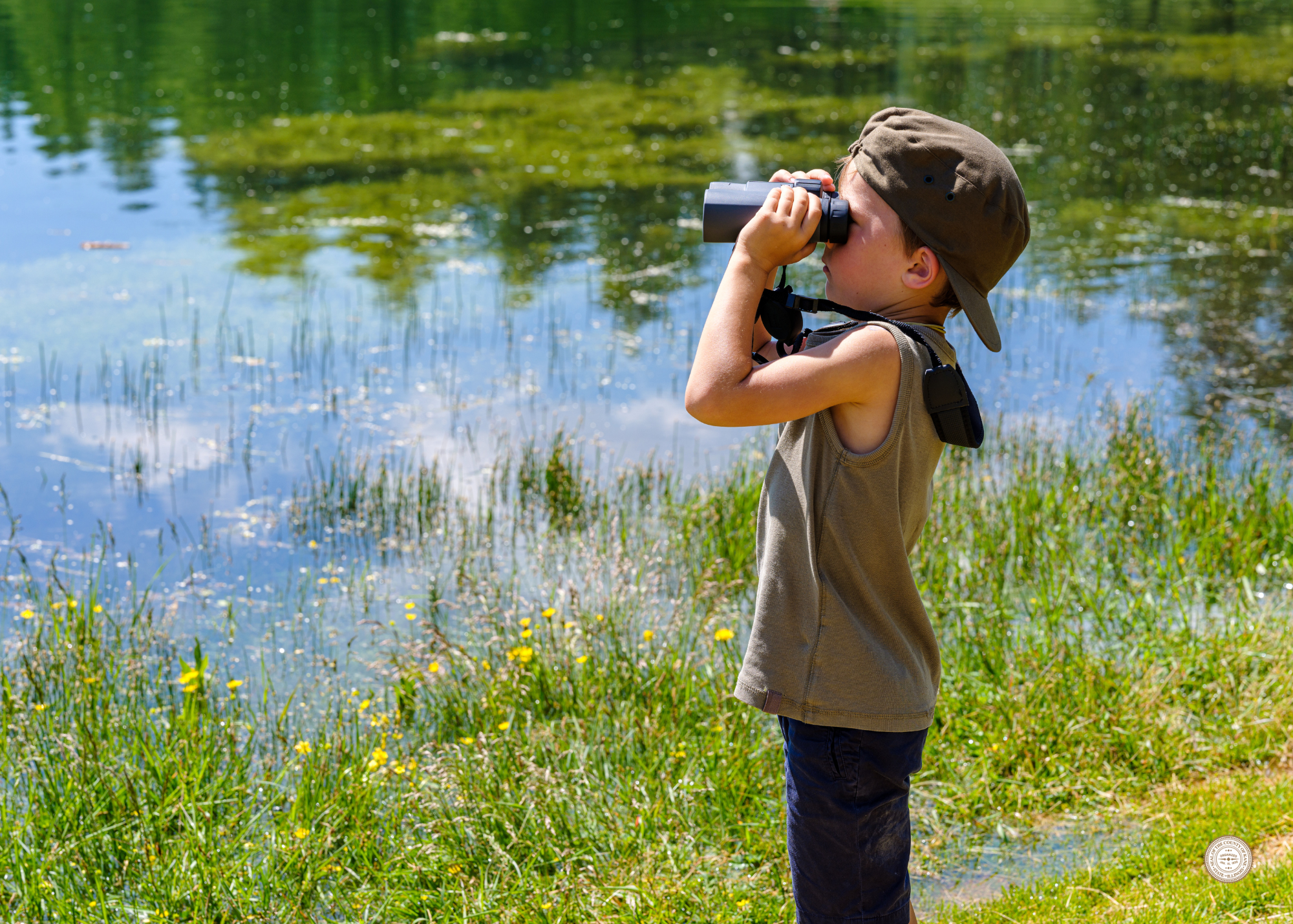 Child by a pod looking into binoculars