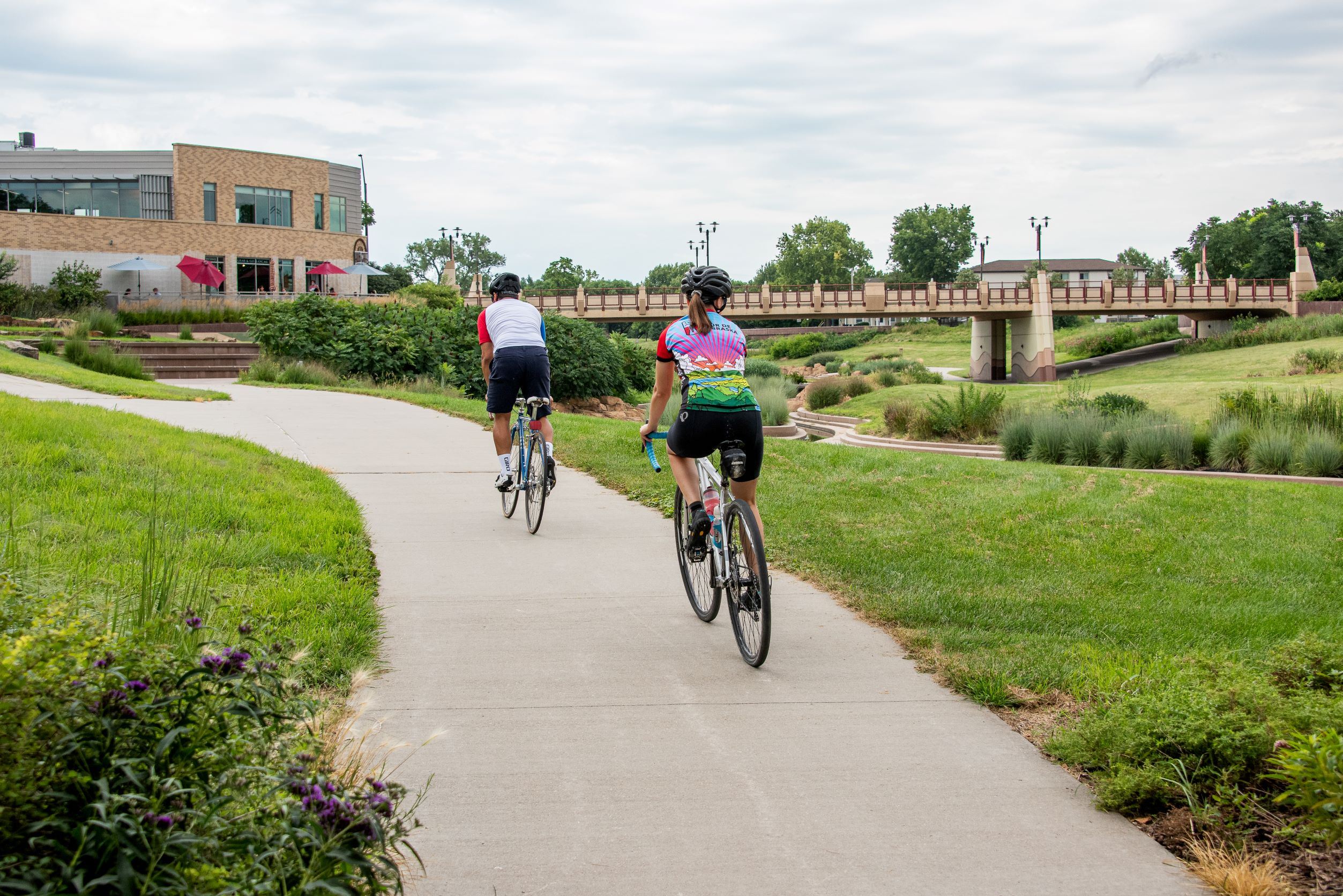 Two people riding bikes on a path