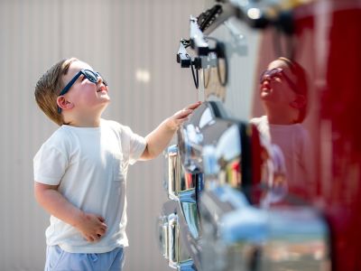 toddler looking at a fire truck